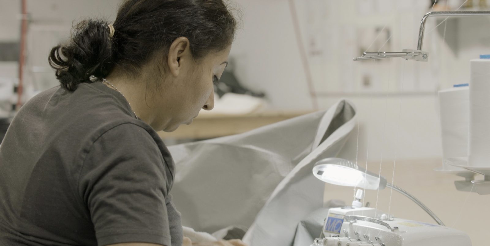 One of Innofa's experts sewing a custom mattress cover